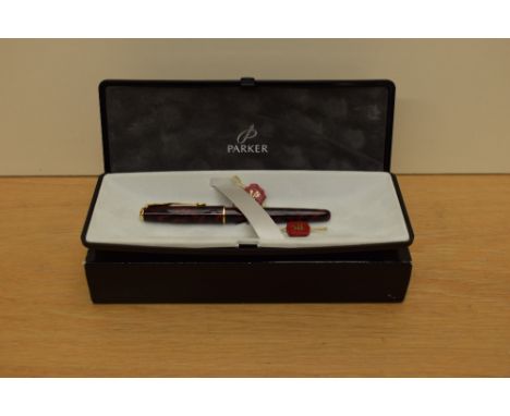 A boxed Parker Sonnet Premiere converter fill fountain pen in Laque red with gold trim having Parker 18K 750 nib