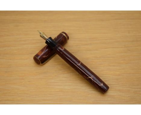 A Parker Premiere button fill fountain pen in mahogany with single gold cap band having Parker Fountain Pen 14K Canada 25 nib