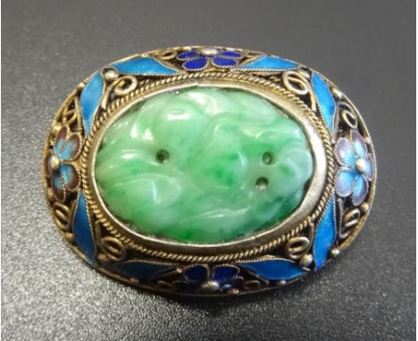 CHINESE JADE AND ENAMEL BROOCHthe central oval carved jade section in enamelled floral decorated surround, in silver gilt, 2.