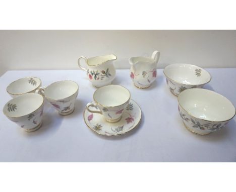 TUSCAN 'WINDSWEPT' BONE CHINA TEA SERVICEthe design of variant form, comprising six cups, six saucers, six side plates, sugar