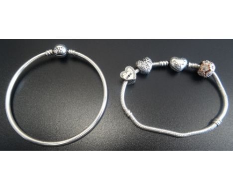 PANDORA MOMENTS SILVER CHARM BRACELET with heart shaped clasp and three Pandora charms; together with a Pandora Moments silve