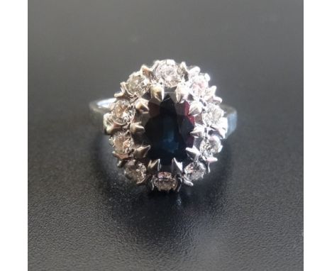 SAPPHIRE AND DIAMOND CLUSTER RINGthe central oval cut sapphire approximately 1ct, in ten diamond surround totalling 0.5cts, o