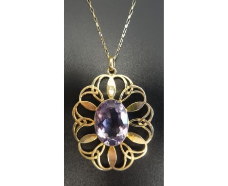 IONA AMETHYST SET NINE CARAT GOLD PENDANTby John Hart, the large oval cut amethyst in pierced entwined surround, on nine cara