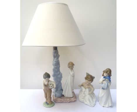 'NAO' FIGURAL TABLE LAMPwith a young girl in nightgown holding a toy clown, raised on a pillow shaped base, 32cm high, with f