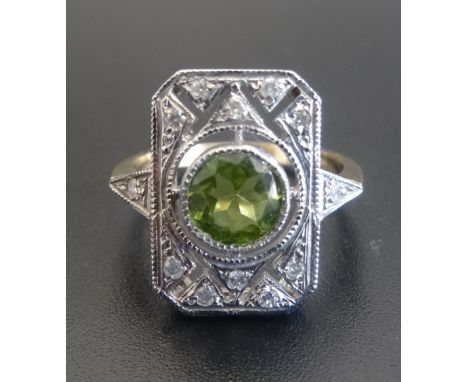 ART DECO STYLE PERIDOT AND DIAMOND PLAQUE RINGthe central round cut peridot in rectangular diamond set pierced surround, on n