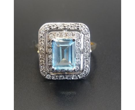 BLUE TOPAZ AND DIAMOND CLUSTER COCKTAIL RINGthe central emerald cut blue topaz approximately 1.25cts, in double diamond surro