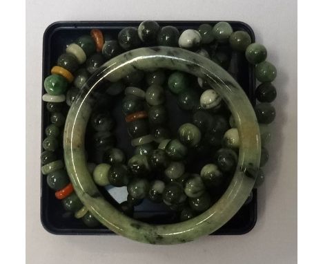 SIX MOTTLED JADE COLOURED HARDSTONE BRACELETSfive bead examples and one bangle (6)