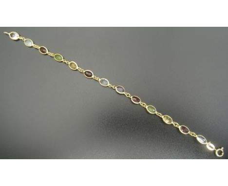 MULTI GEM SET BRACELETin eighteen carat gold, set with oval cut aquamarine, amethyst, peridot, citrine and garnet, approximat