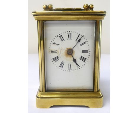 FRENCH BRASS CASED CARRIAGE CLOCKearly 20th century, with black Roman numerals on white enamel, 10.4cm high, with key
