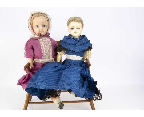 A late 19th century German wax over composition doll with sleeping eyes, deep blue glass eyes, blonde wig, stuffed body with 