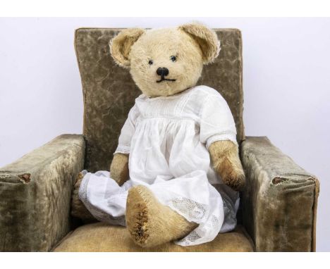 A British 1920s Teddy Bear,  with light golden mohair, small clear and black glass eyes with grey/blue painted backs, pronoun