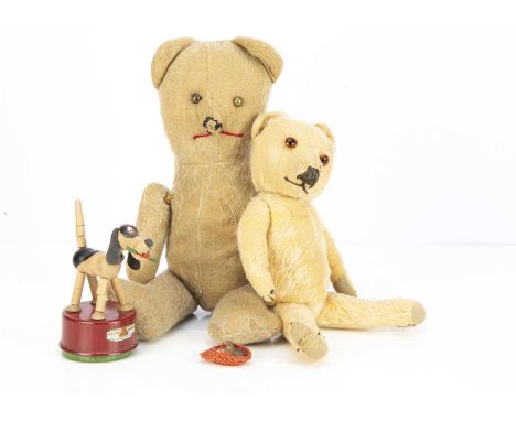 A post-war Merrythought Teddy Bear, with light golden mohair, orange and black glass eyes, black stitched nose, mouth and cla