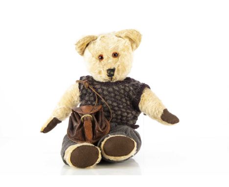 A post-war British Teddy Bear, with blonde mohair, orange and black glass eyes, black stitched nose, swivel head, jointed lim