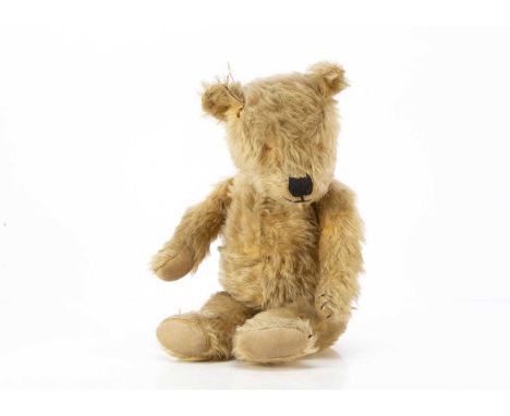 A 1930's Chiltern-type Teddy Bear,  with golden mohair, black stitched nose and mouth, swivel head, jointed limbs and brushed