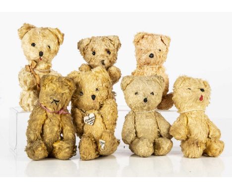 Seven post-war small Polish Teddy Bears, with artificial silk plush, fixed heads and pin jointed; one with cloth seam label -