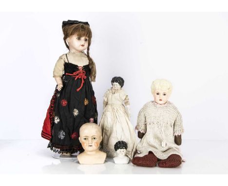 An Unis 71 149 child doll, with blue glass eyes, in French national costume --17 1/2in. (44.5cm.) high, four other shoulder-h