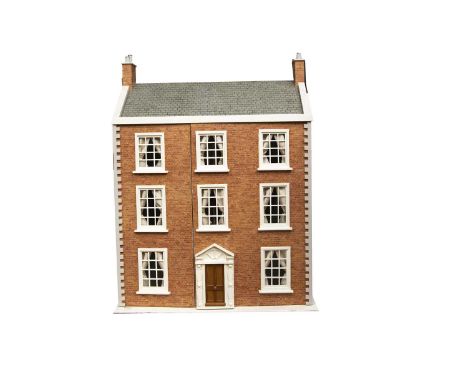 A large recent wooden dolls' house, brick paper facade, grey tile paper roof, painted wooden windows, doors and coining, fron