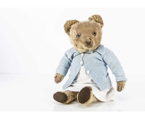 A British 1920s Teddy Bear, with blonde mohair, clear and black glass eyes with brown painted backs, swivel head, jointed lim