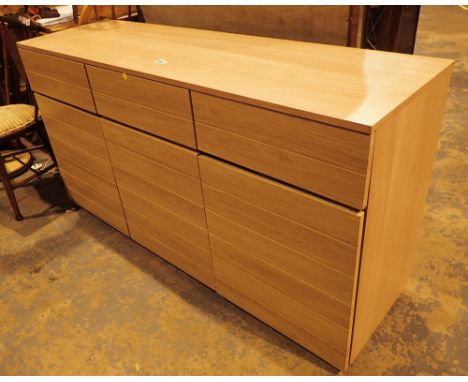 Modern light pine veneered sideboard three drawers over three cupboards 