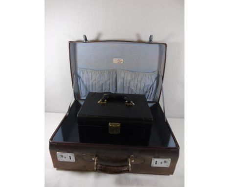 Vintage leather suitcase with a blue lining together with a leather vanity case