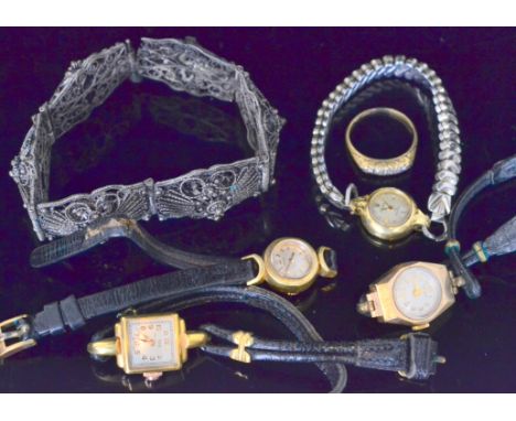 Three mid 20th Century ladies gold wrist watches to include an 18ct Rolex example, a further metal watch, a diamond boat shap