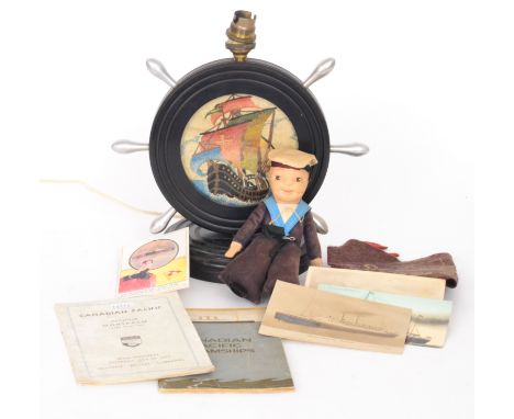 A small Norah Wellings sailor doll for the Oriana, a QEII felt pennant, four postcards and two related booklets and a 1930s e