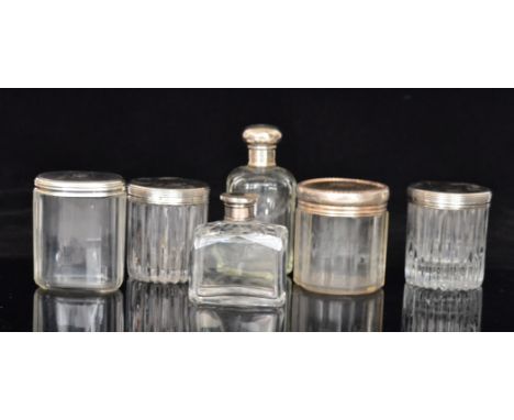 Six assorted silver topped scent bottles to include two plain French bottles and three engine turned examples, various styles