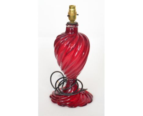 A post-war Italian Murano glass lamp in the manner of Seguso with a wrythen fluted foot below a wrythen fluted ovoid form bod