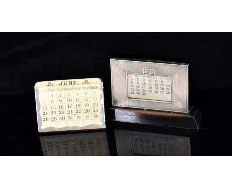 A hallmarked silver mounted and ebonised wood desk calendar with engine turned decoration, on wooden plinth base, Birmingham 