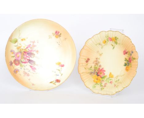 A Royal Worcester blush ivory shallow plate decorated with hand painted and transfer fuchsia and spring flowers against a pal