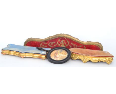 Two 19th Century gilt velvet top clock stands of serpentine outline together with a similar wall bracket and a turned hand sc