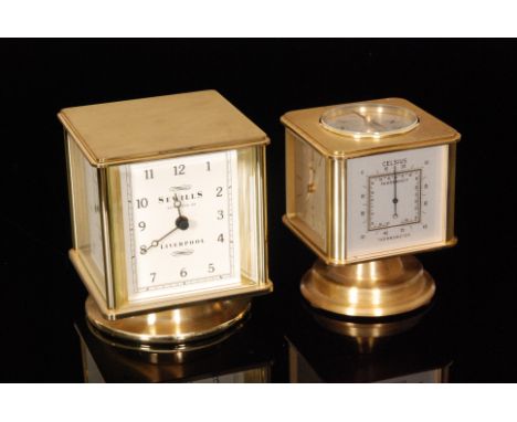 A Sewills of Liverpool revolving brass cased combination hygrometer, barometer, thermometer and clock, height 11cm, together 