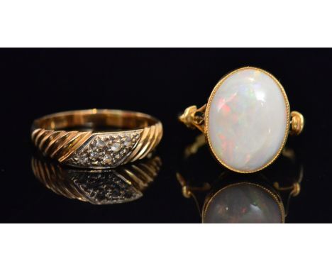 An 18ct opal dress ring, the oval collet set opal within raised pierced setting, stamped, ring size M, together with another 