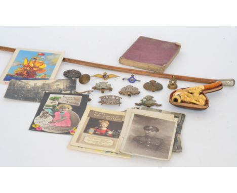 A swagger stick, a collection of WWI badges and a Meerschaum pipe, together with a collection of photographs, science fiction