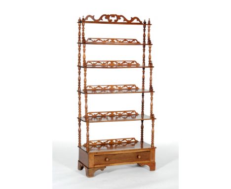 A Victorian mahogany six-tier 'waterfall' style what-not, with pierced galleries and turned spindle supports above a frieze d