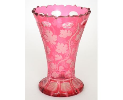 A large late 19th Century Bohemian crystal glass vase of footed flared form cased in ruby over clear and flash cut with fruit