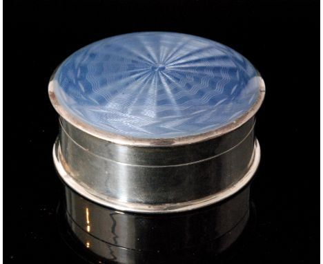 A hallmarked silver circular box and cover the plain body below hinged cover with pale blue enamel decoration opening to reve