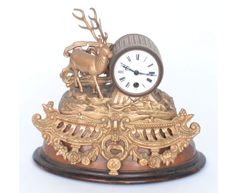 A 19th French gilt metal mantle clock mounted with a stag on a wooden base, height 32cm