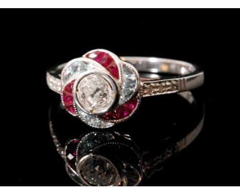 An 18ct white gold an aquamarine, diamond and ruby ring, central old cut diamond, weight approximately .40ct, within an alter