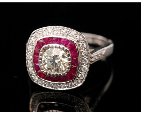 A 18ct hallmarked white gold ruby and diamond cluster target ring, central brilliant cut diamond, weight approximately .80ct 