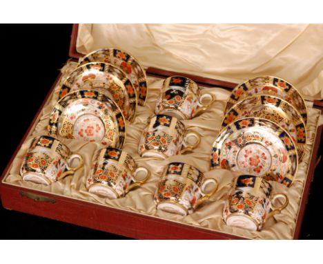 An early 20th Century Royal Crown Derby cased set of six coffee cans and saucers, each decorated in the Imari 2614 pattern, e