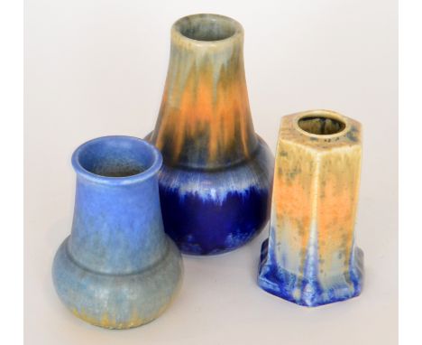 Three pieces of Ruskin Pottery crystalline glaze comprising a vase of globe and shaft form decorated in a streaked orange, gr