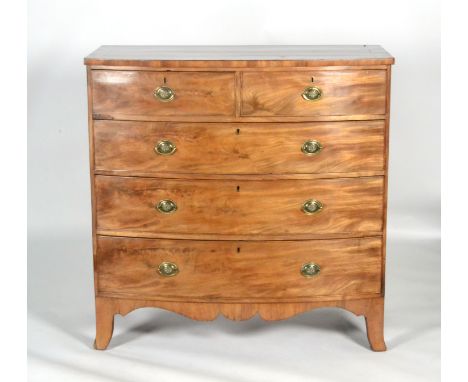 A late Georgian crossbanded mahogany bow-fronted chest of two short over three long cockbeaded drawers, with oval brass drop 