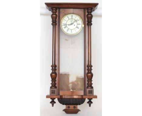 A 19th Century Vienna walnut cased regulator wall clock with weight driven movement enclosed by a glazed pillar door, height 