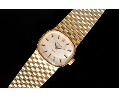 A ladies 14ct Rolex manual wind wristwatch, the shaped square face with silvered dial, black and gilt baton markers and gilt 
