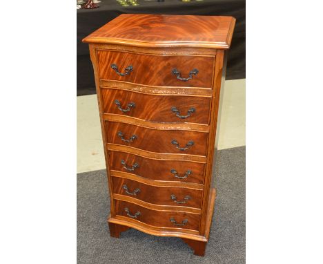 A George III style mahogany serpentine crossbanded chest of six drawers on bracket feet, width 48cm