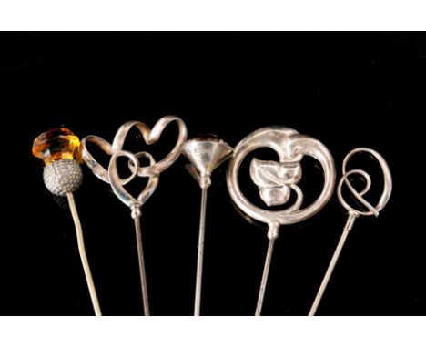 Three Charles Horner Arts and Crafts silver hat pins, one with twisted tendrils, the other with stylised silver leaf surmount