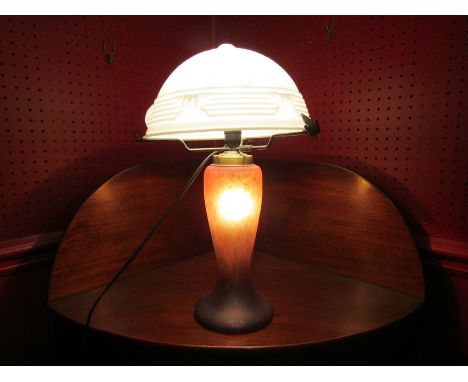 A mottled coloured glass table lamp with white glass shade