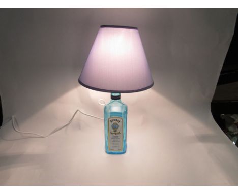 A Bombay Sapphire Dry Gin table lamp with blue shade