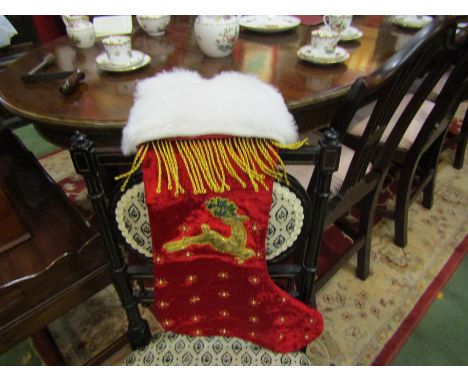 A vintage Harrods luxury Christmas stocking in red plush and gold threads, reindeer design